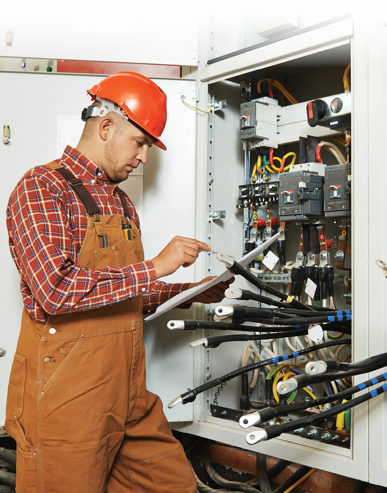 A man in a hard hat is working on electrical equipment. AI generated content