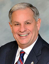 A man wearing a suit and tie is smiling for the camera. AI generated content