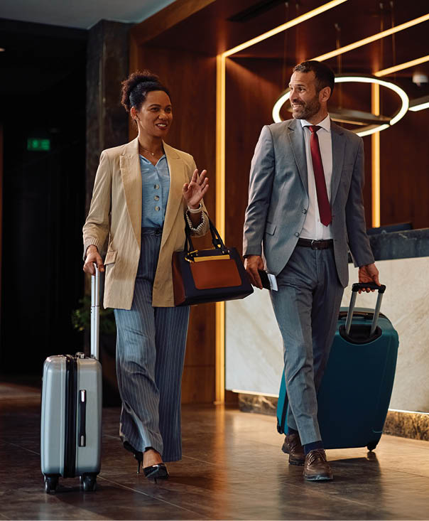 A man and woman are walking together, each carrying luggage. AI generated content