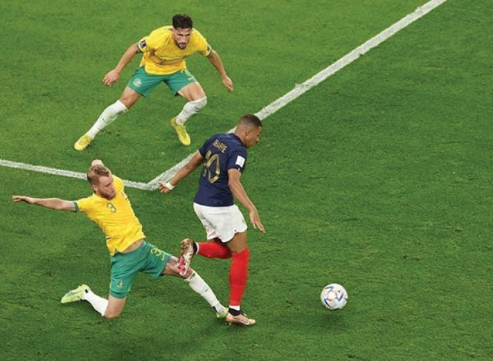 Two men in green and yellow uniforms are playing soccer on a field. One man is kicking the ball while the other man is trying to block him. AI generated content