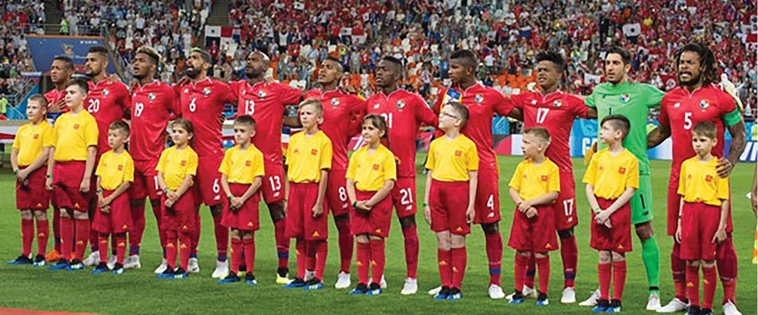 A group of young boys wearing red and yellow jerseys stand on a field. AI generated content