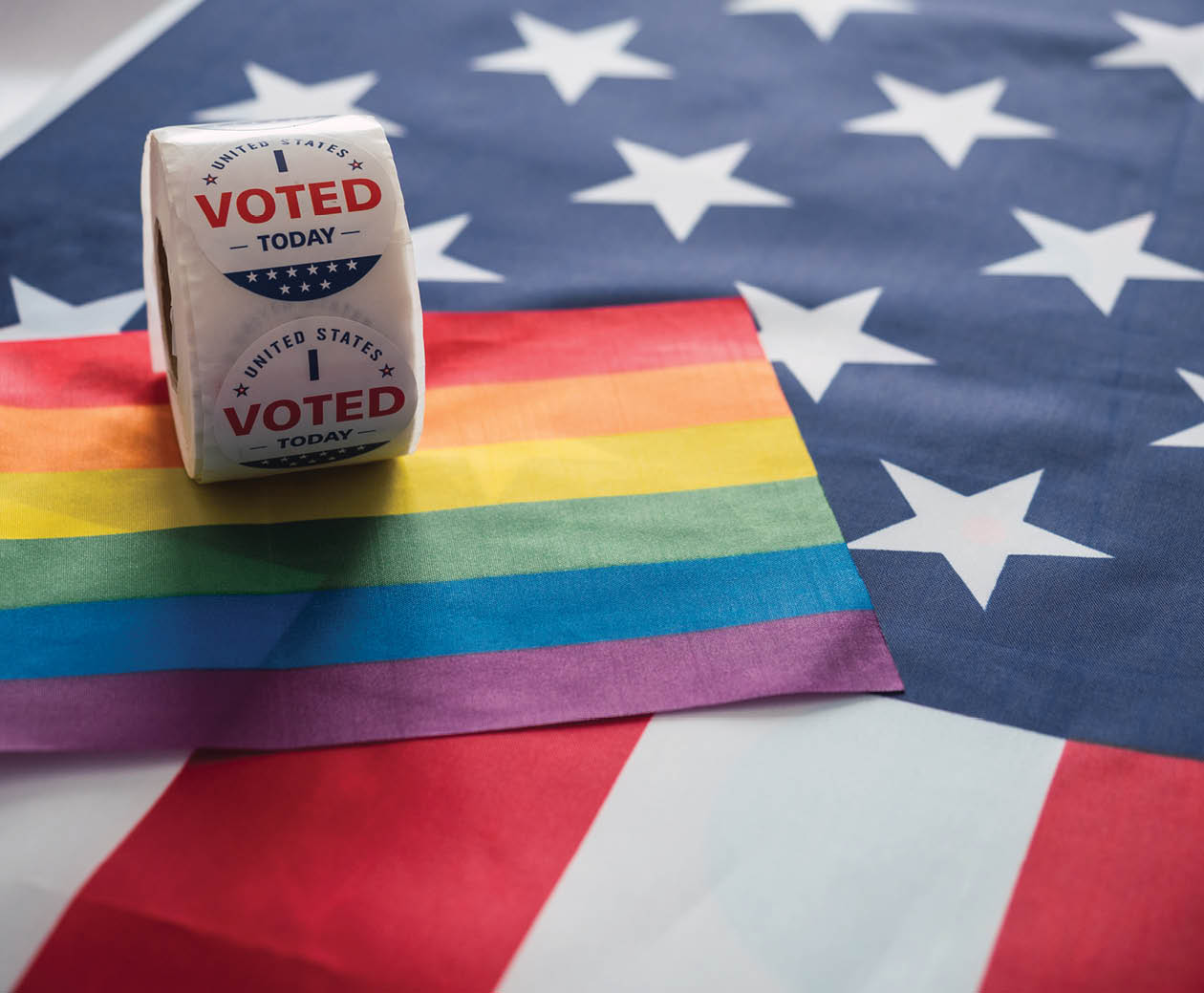 United States flag with LGBT flag and “I voted" sticker. presidential election concept