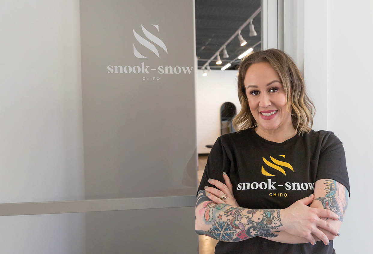 A woman wearing a black shirt with a tattoo on her arm. Description generated by AI