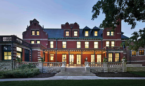 A large red brick building with many windows. Description generated by AI