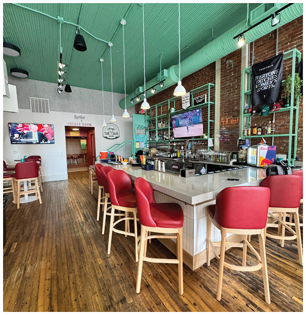 A restaurant with a bar and red chairs. Description generated by AI