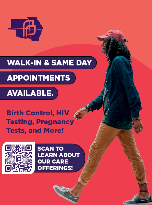 A woman wearing a red hat and blue shirt is walking. Description generated by AI
