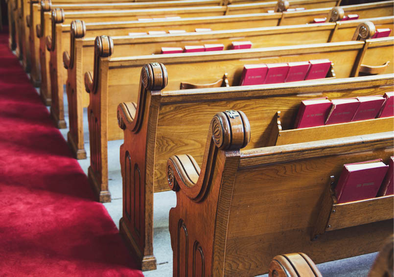 Large old wooden church pews and aisle