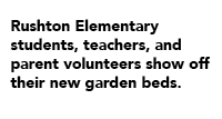 Rushton Elementary students, teachers, and parent volunteers show off their new garden beds.