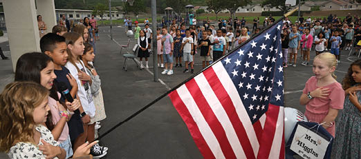 Oak Grove students stand for the flag salute at the start of the first day of school. Photo by Steven Georges/CUSD Insider