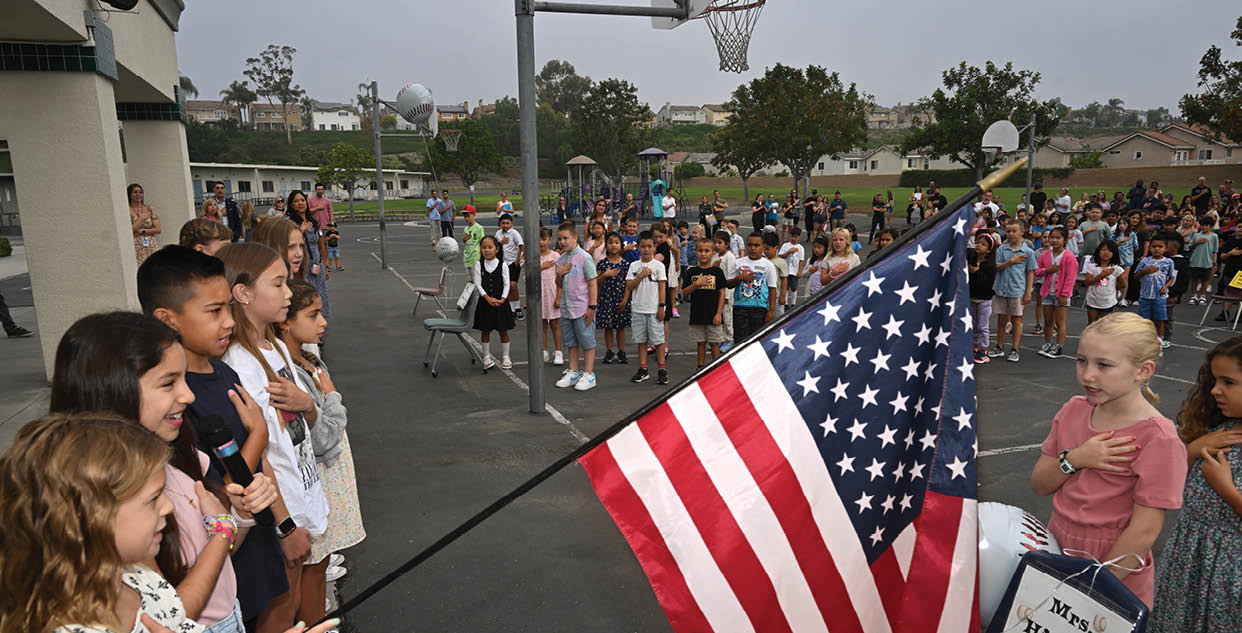 Oak Grove students stand for the flag salute at the start of the first day of school. Photo by Steven Georges/CUSD Insider