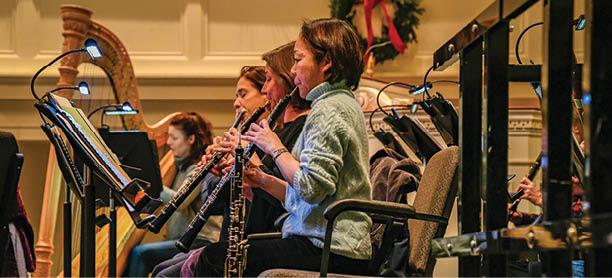 An interior view of clarinet players rehearsing for a concert