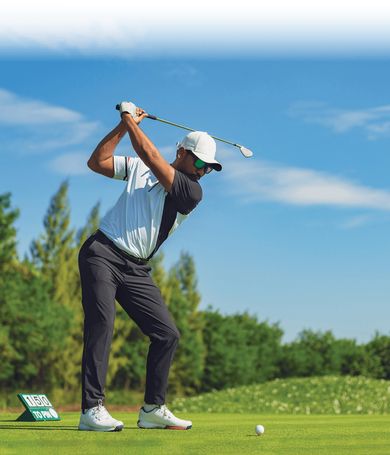 Asian man golfing on the course in summer