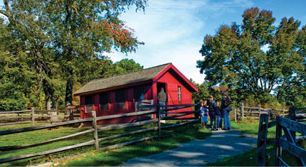 An exterior view of a red chicken coop at Fosterfield's Farm.