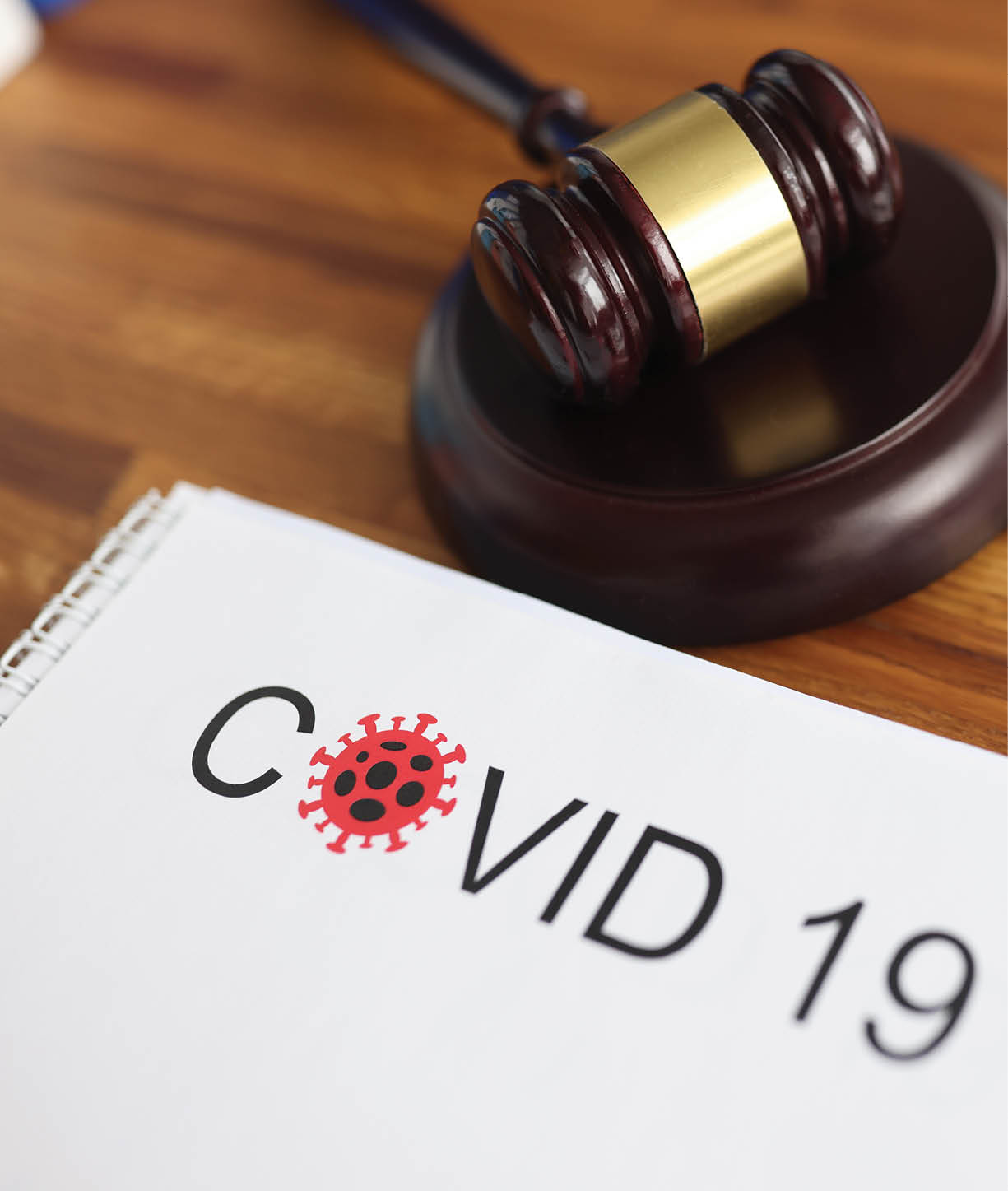 Judges gavel and legal documents lying on table in courthouse closeup  Criminal liability for intentional infection of covid 19 concept 