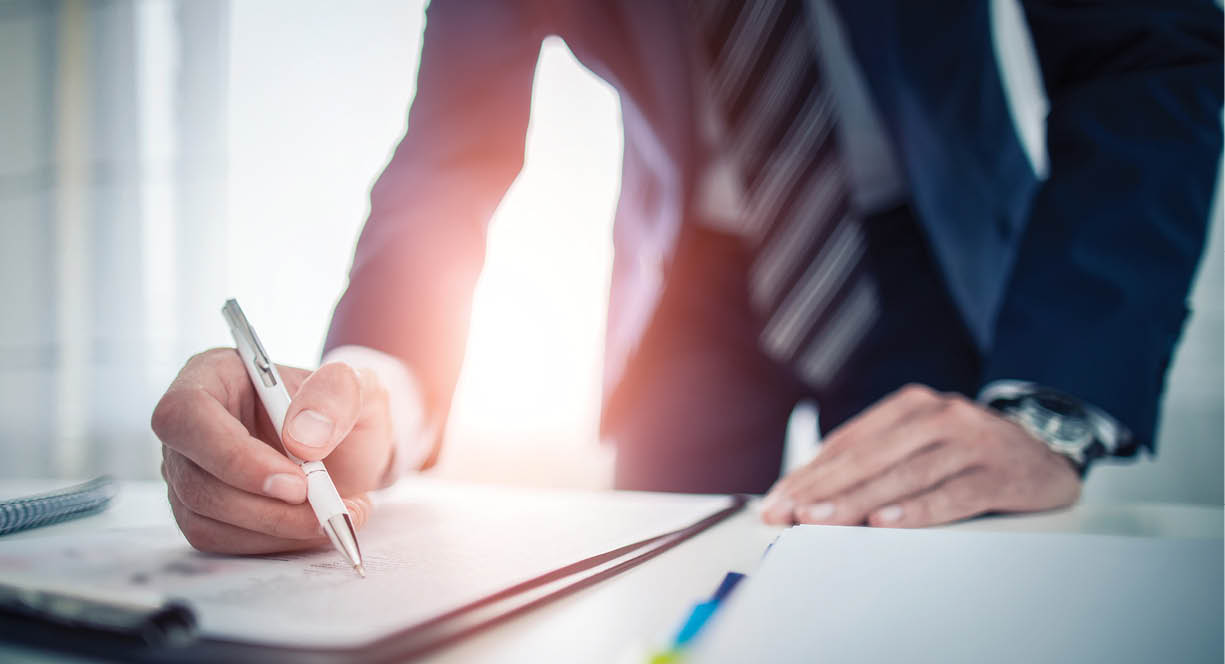 Business man signing contract document on office desk, making a deal 