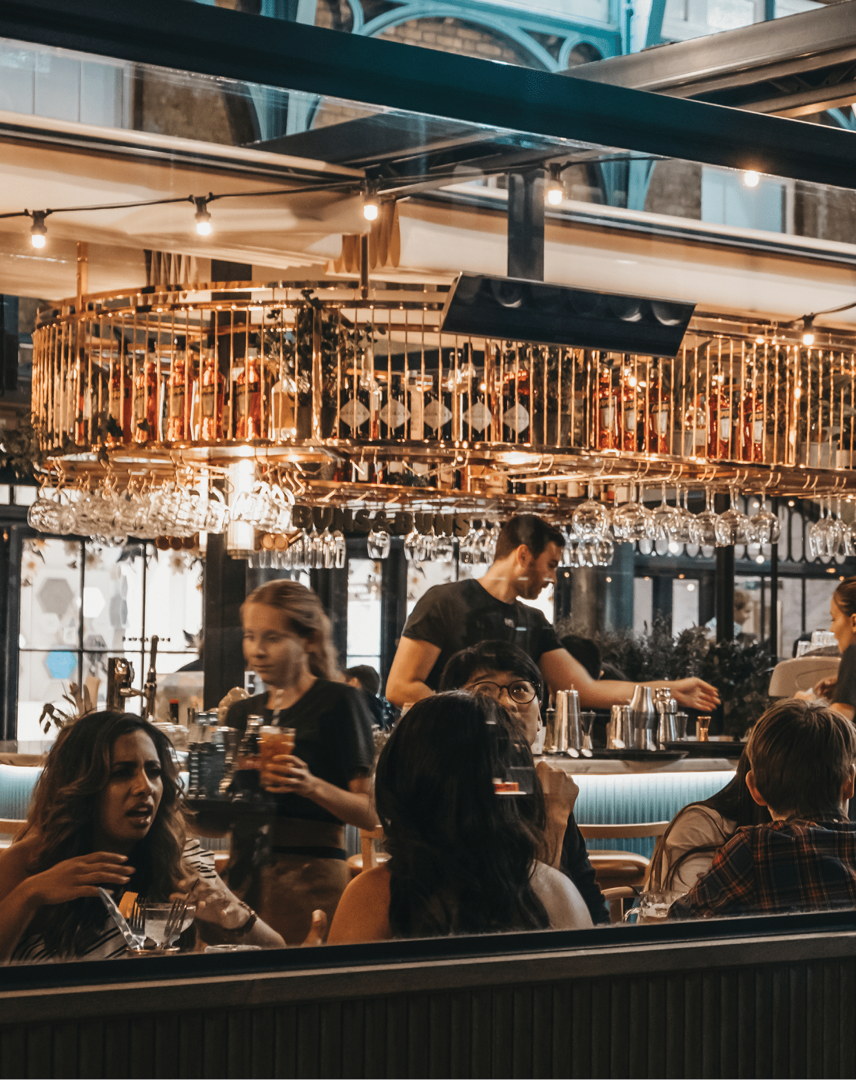 London, UK - August 31, 2019: View through the window of staff and customers inside Buns and Buns restaurant in Covent Garden Market, one of the most popular tourist sites in London, UK 
