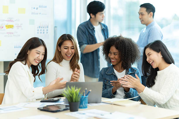 Business people showing team work while working in board room in office interior. People helping one of their colleague to finish new business plan. Business concept. Team work.