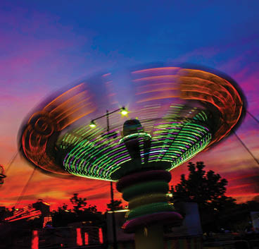 A green and purple merry go round. Description generated by AI