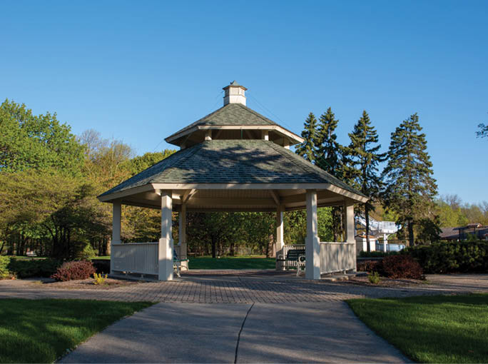 A gazebo with a white roof and a black top. Description generated by AI