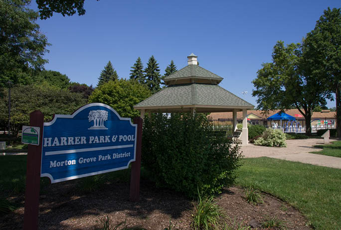 A sign for Harper Park Pool is in front of a gazebo. Description generated by AI