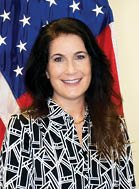A woman wearing a black and white shirt. Description generated by AI