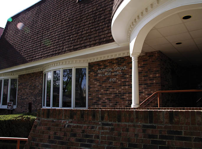 A brick building with a brown roof. Description generated by AI