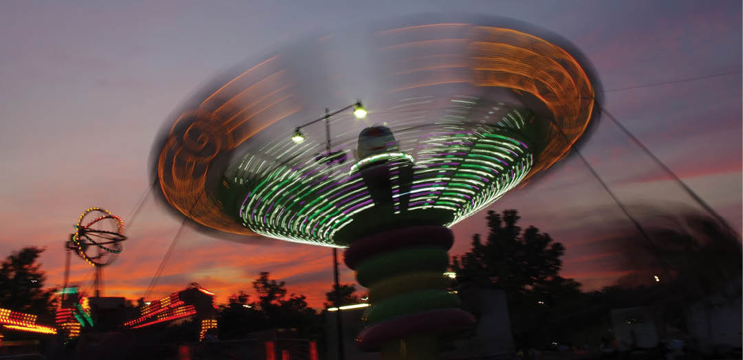 The swings ride (with light trails showing) at the Carnival    Art Piece