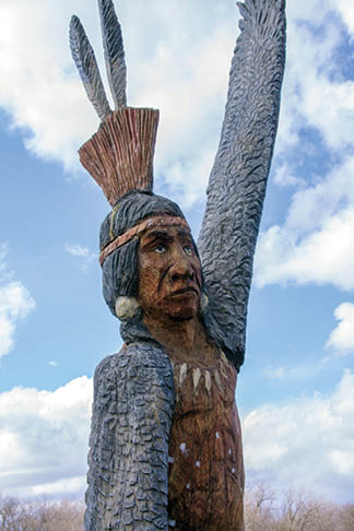MG Chamber of Commerce Community Guide pics 2016  carved Indian Sculpture/statue behind the Yehl House/Morton Grove Historical Museum   Native American Potawatomi Tribe Eagle Dance sculpture/statue, which was carved from a rescued portion of Morton Grove's Indian Marker Tree