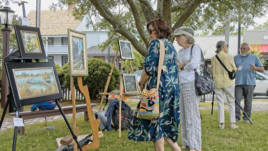 A woman is painting a picture of a boat. Description generated by AI