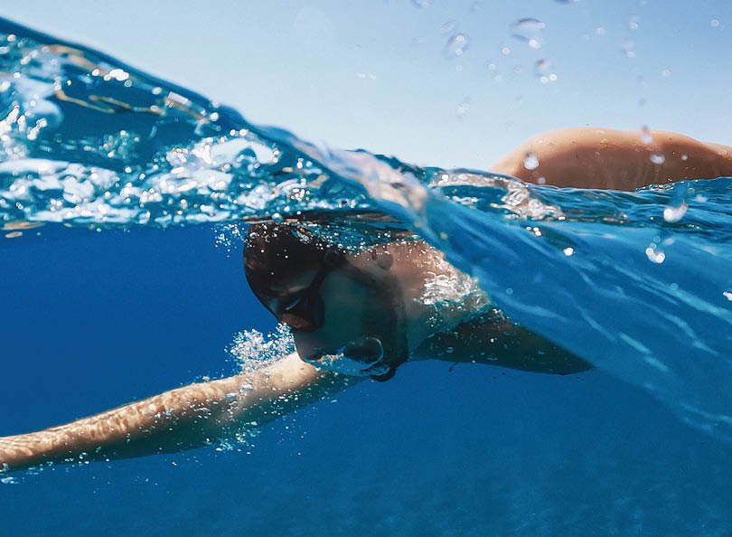 Man swimming into the ocean