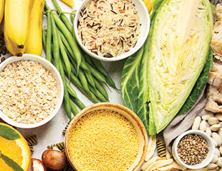 Selection of good carbohydrates sources - vegetables, fruits, grains, legumes, nuts and seeds on white background, top view.