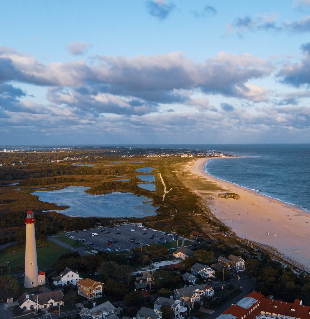 An aerial image showing the North most point of the tip of Cape May, NJ. It’s famous lighthouse, on the national historic register, looks out upon the deep blue Atlantic Ocean.