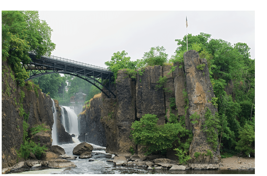 Paterson, NJ / USA - 7/8/20: Landscape view of the Great Falls of the Passaic River. a prominent waterfall, 77 feet (23 m) high, on the Passaic River in the city of Paterson in Passaic County.
