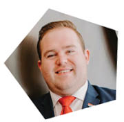 A man wearing a suit and tie is smiling for the camera. AI generated content