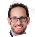 A man wearing glasses and a suit smiles for the camera. AI generated content