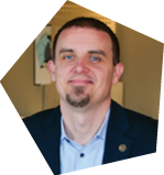 A man wearing a suit and tie is sitting at a table. AI generated content