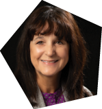A woman wearing a purple shirt and a gray jacket is smiling for the camera. AI generated content