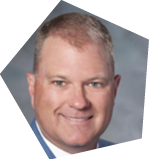 A man wearing a blue jacket and a yellow tie is smiling for the camera. AI generated content