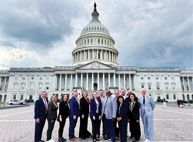 A group of people posing in front of the capitol building. AI generated content