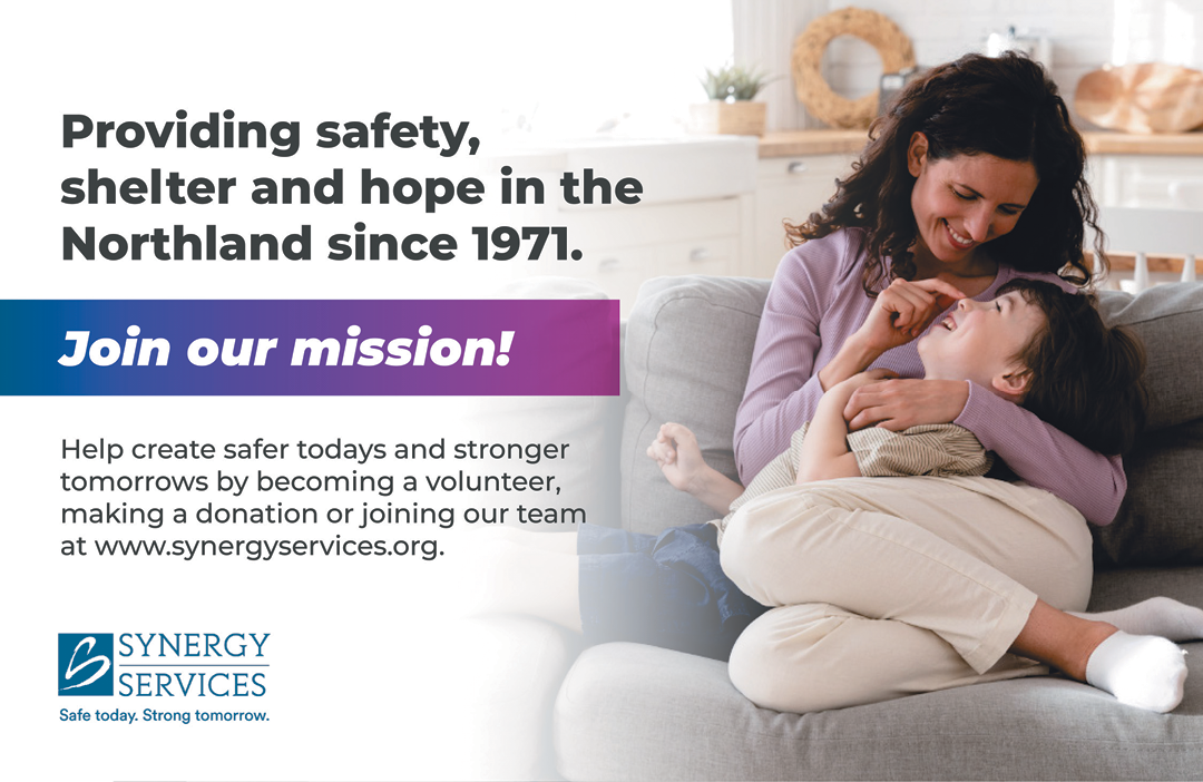 A woman is holding a child on a couch, and they are both smiling. They are posing for a photo. AI generated content