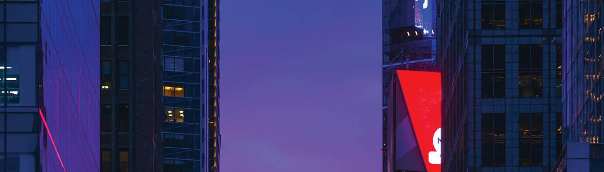 New York 42nd Street in Colorful Rainbow Toned Sunset background, showing cars stopping at a red light on 6th Avenue, people crossing the street, and glass office tower facades reflecting the colorful sky juxtaposed with lit up LED display panels and signages 