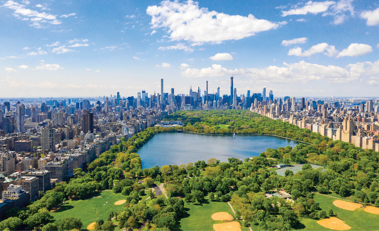 Aerial view of the Central park in New York with golf fields and tall skyscrapers surrounding the park 