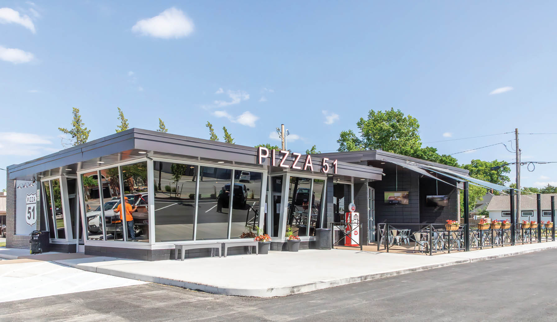 A pizza restaurant with a black and grey roof. AI generated content