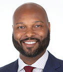 A man wearing a suit and tie is smiling for the camera. AI generated content