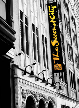A black and white photo of a building with a yellow sign that says “The Second City". Description generated by AI
