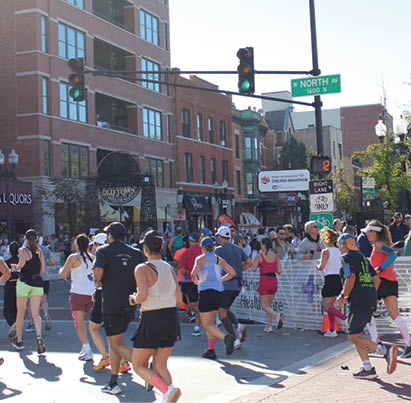 A group of people running on a street. Description generated by AI