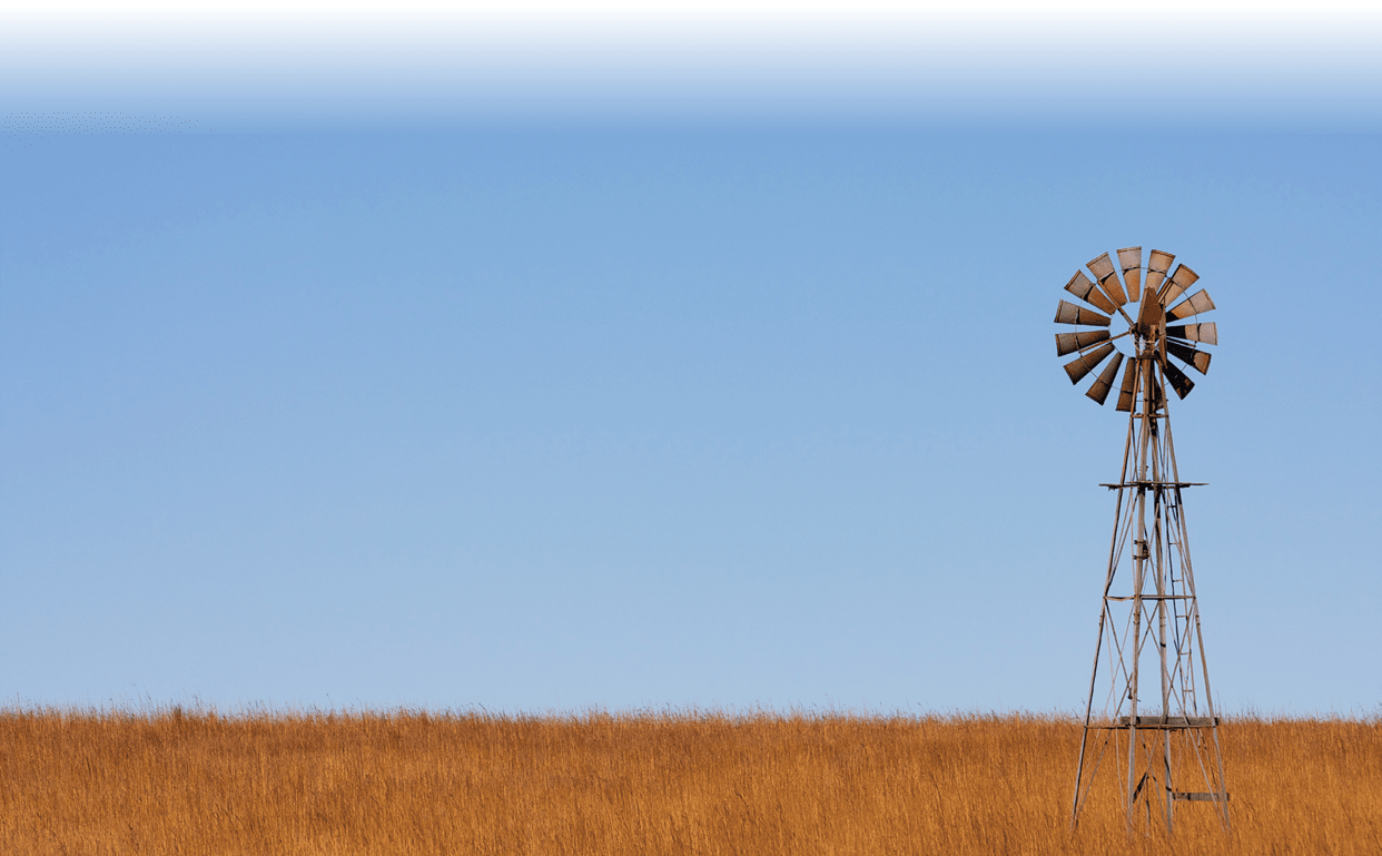 Windmill on the Plains of Kansas against a Blue Sky