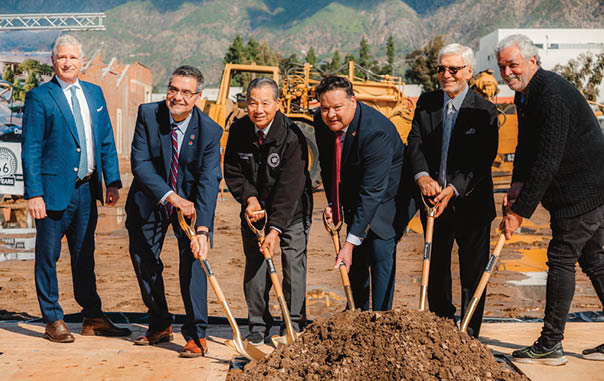 A group of men are digging in a dirt pit. Description generated by AI