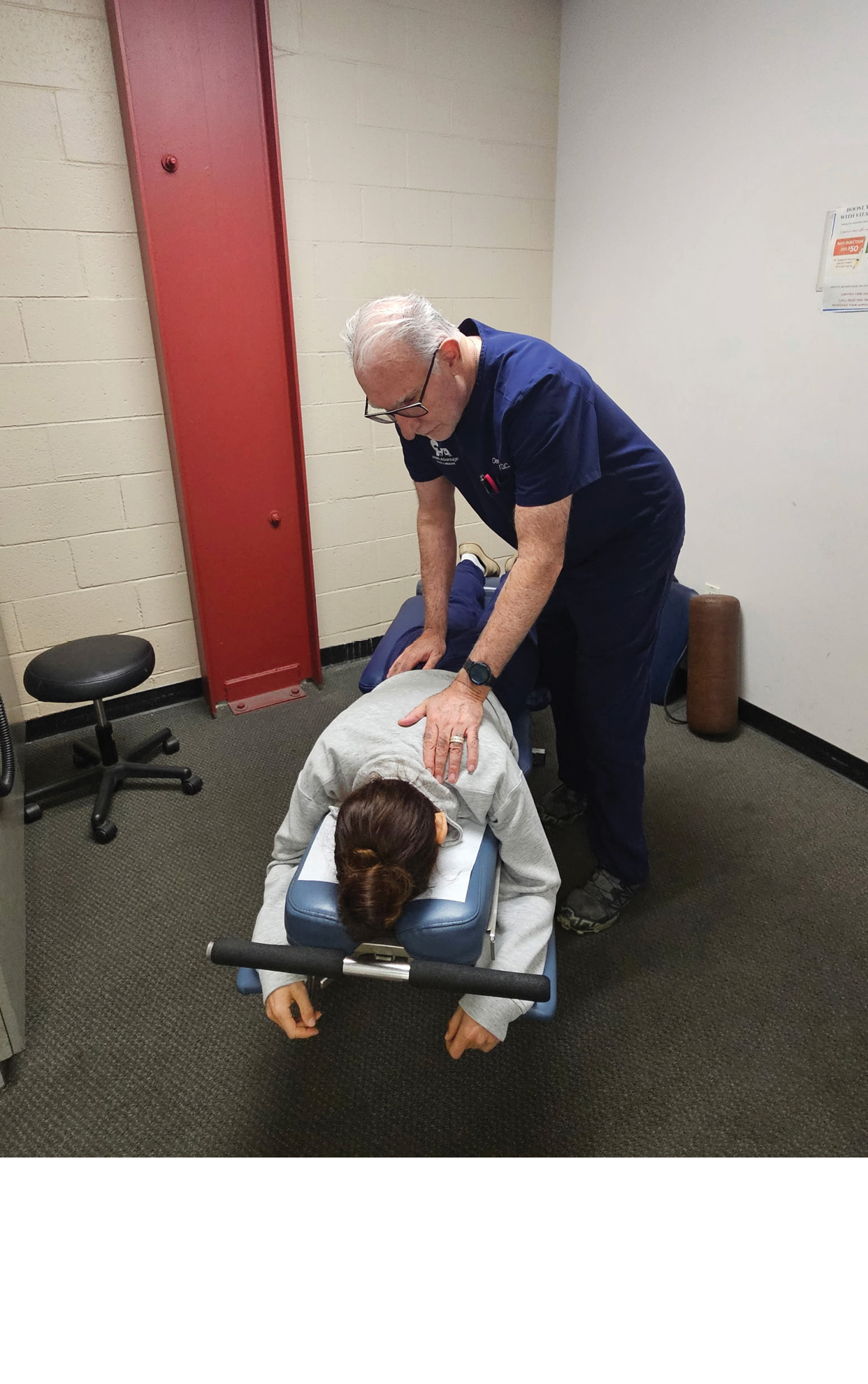 A man is giving a massage to a woman. Description generated by AI