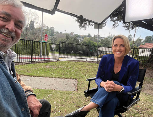 A man and a woman sitting in chairs. Description generated by AI